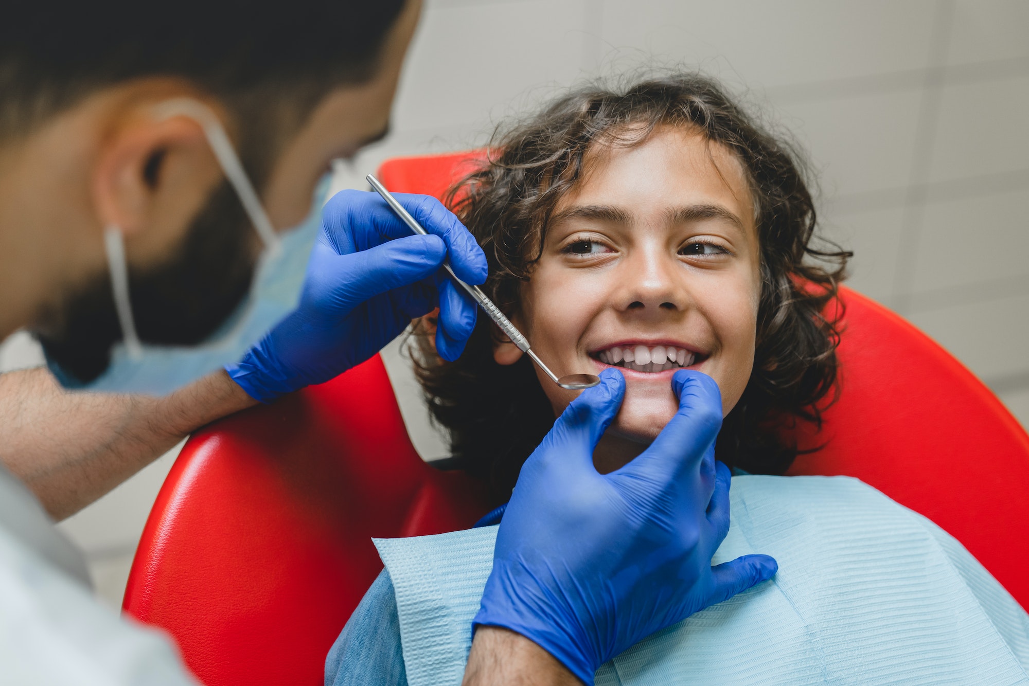 Kid`s boy`s jaws, white healthy teeth while doctor stomatologist dentist making doing checkup